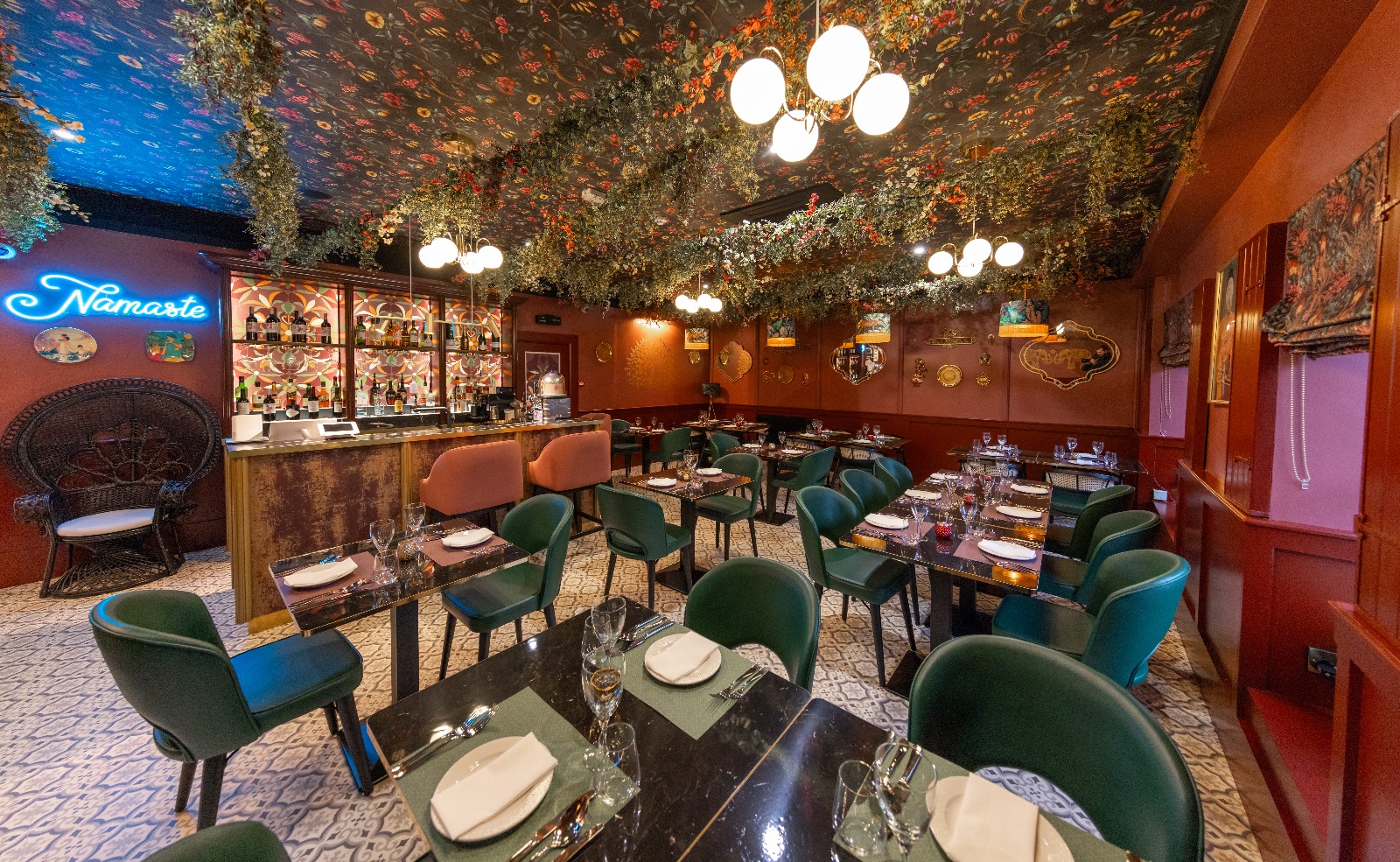 a dining room with tables and chairs with white tablecloths.