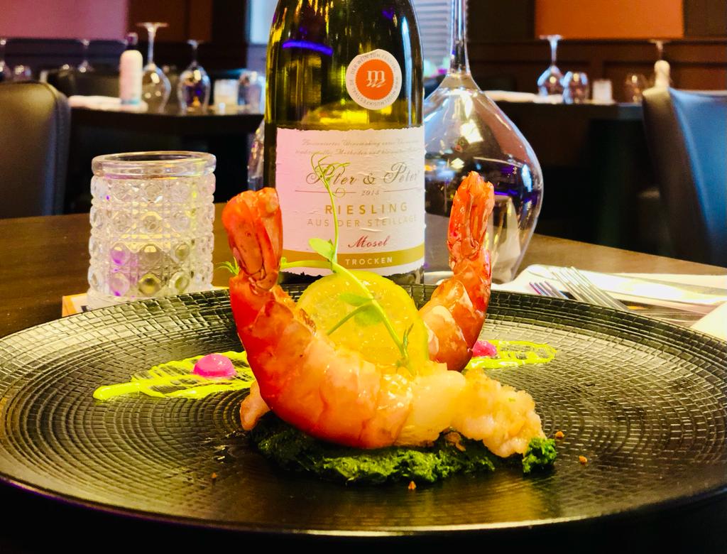 a dining room with tables and chairs with white tablecloths